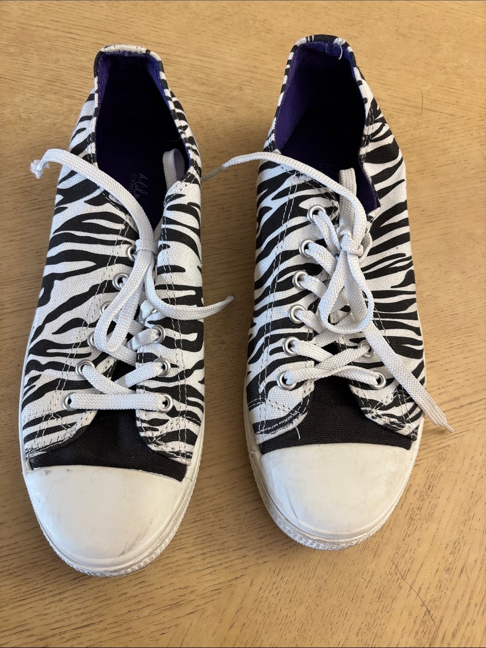Miley Cyrus Zebra-Print Low-Top Sneakers in Black, White & Purple Lining.